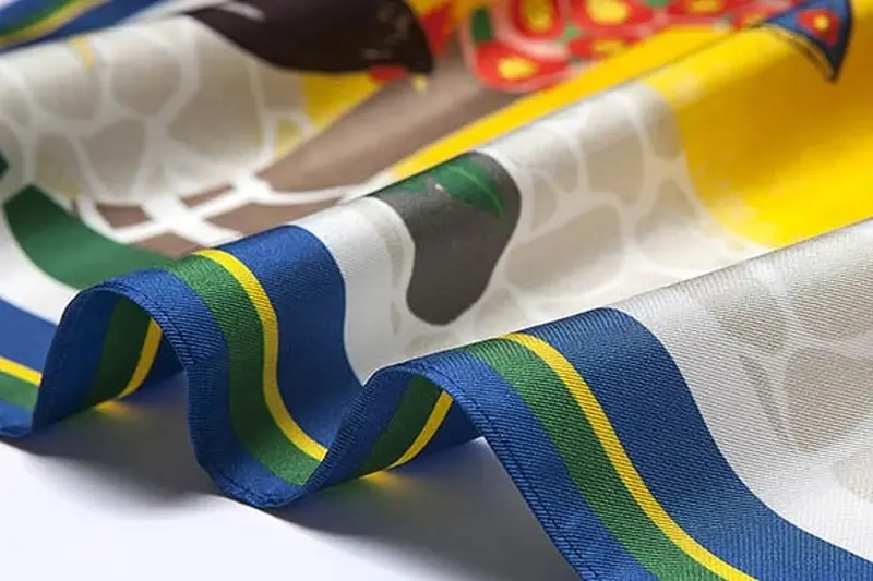 Hand-rolled and machine-finished silk scarf edges