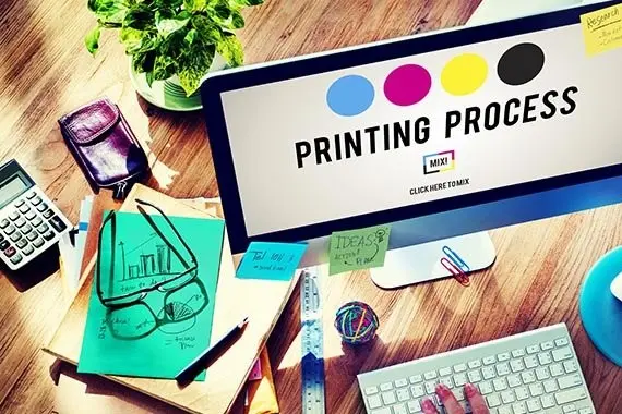 Desktop workstation showing print color planning and artwork notes