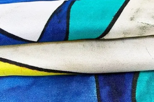 Folded printed silk twill showing the colored face and reverse side