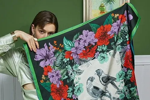 Floral and bird print silk scarf held open