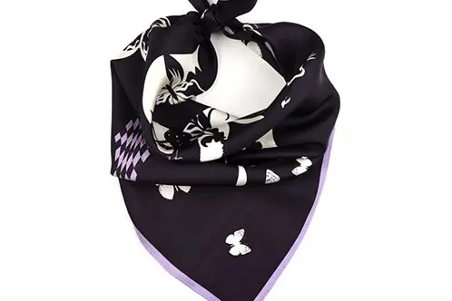 Black printed silk twill scarf arranged to show body and folded structure