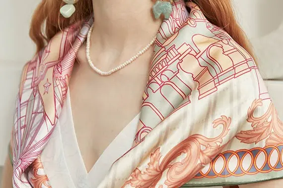 Printed silk scarf draped over the shoulders to show surface and body