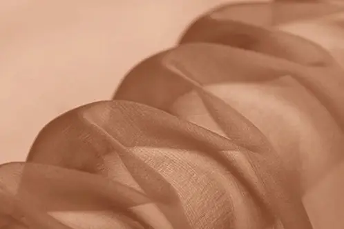 Sheer silk chiffon showing changes in transparency where the fabric folds