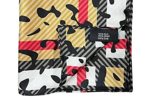 Printed silk scarf folded to show the face, reverse and hand-rolled edge