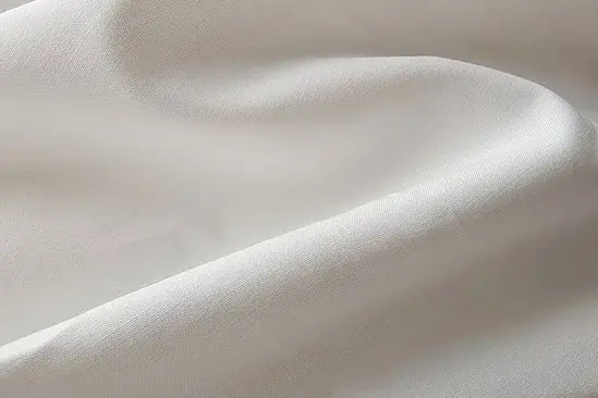 White cotton fabric showing a matte woven surface
