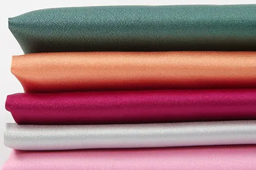Folded polyester satin samples in several colors