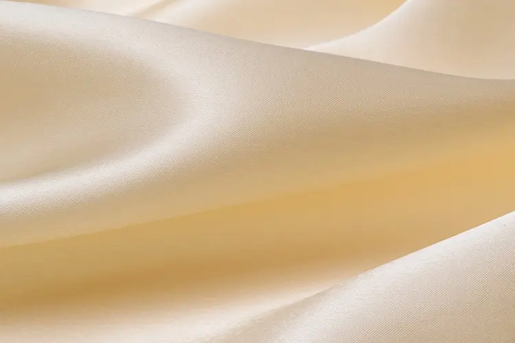 Ivory silk satin showing a smooth surface and visible sheen