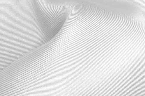 Close view of diagonal ribs across white twill fabric