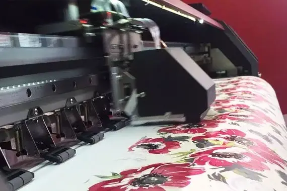 Digital textile printer applying a multicolor floral pattern to fabric