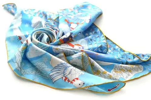 Blue printed silk scarf arranged to show its drape and edge