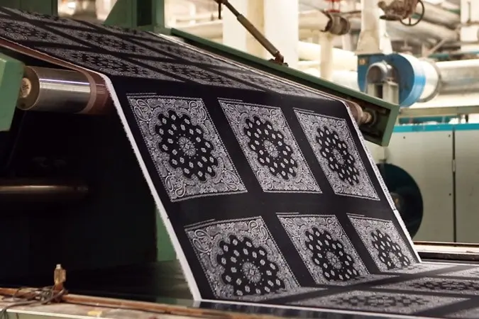 Patterned fabric moving through an industrial textile printing line
