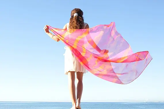 Oversized printed scarf held open to show large-format scale and drape