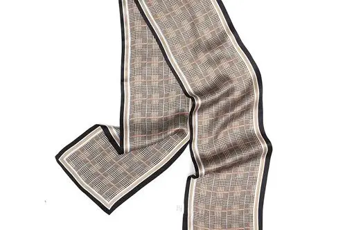 Long narrow checked scarf laid out to show its extended proportions