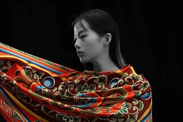 Large printed scarf draped across the shoulders to show scale and styling use