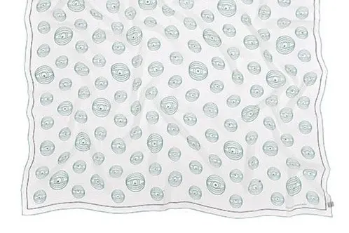 Printed silk scarf laid flat to show its surface, border and finished edge