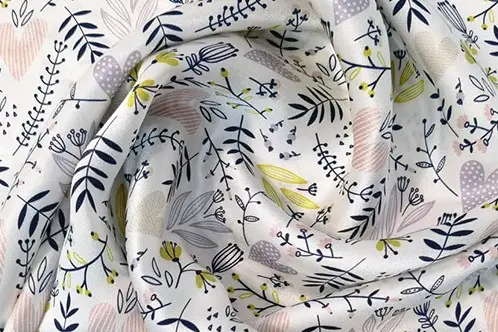 Printed silk fabric gathered into soft folds that change how creases appear