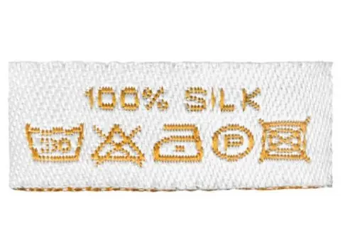 100% silk care label with washing, bleaching, ironing and dry-cleaning symbols