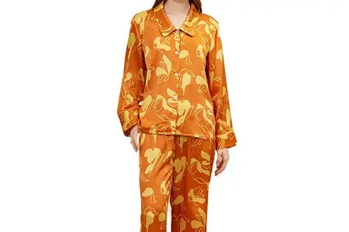 Orange printed silk pajama set with button front, collar, cuffs and piping