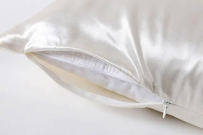 White silk pillowcase opened to show its concealed zipper and inner stitching
