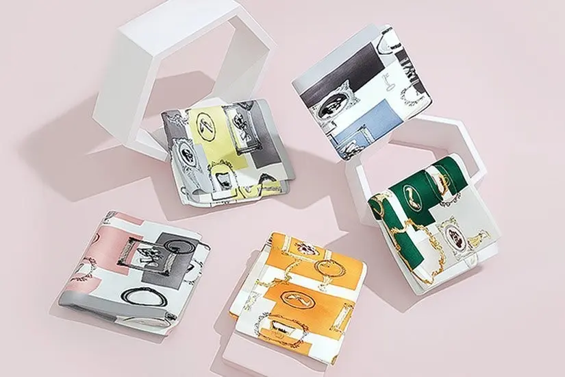 Folded printed silk scarves arranged for fabric, print and edge review