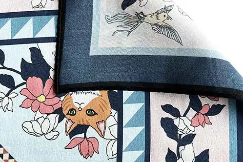 Close view of a printed silk scarf surface, border and stitched edge